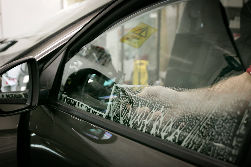 Cleaning a car window ready to install tint