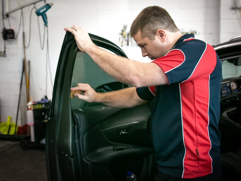 North Lakes professional window tinter installing car window tint